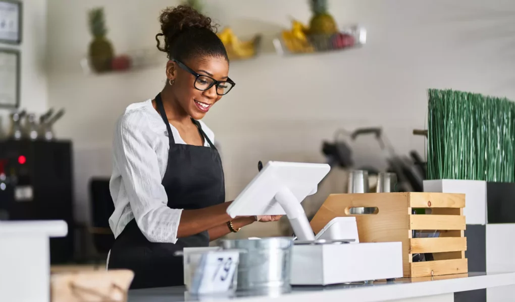 friendly-african-american-shop-assistant-using-pos